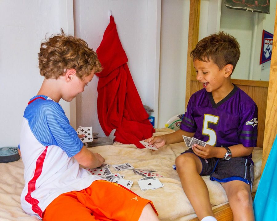 Young Airy campers playing cards in their bunk