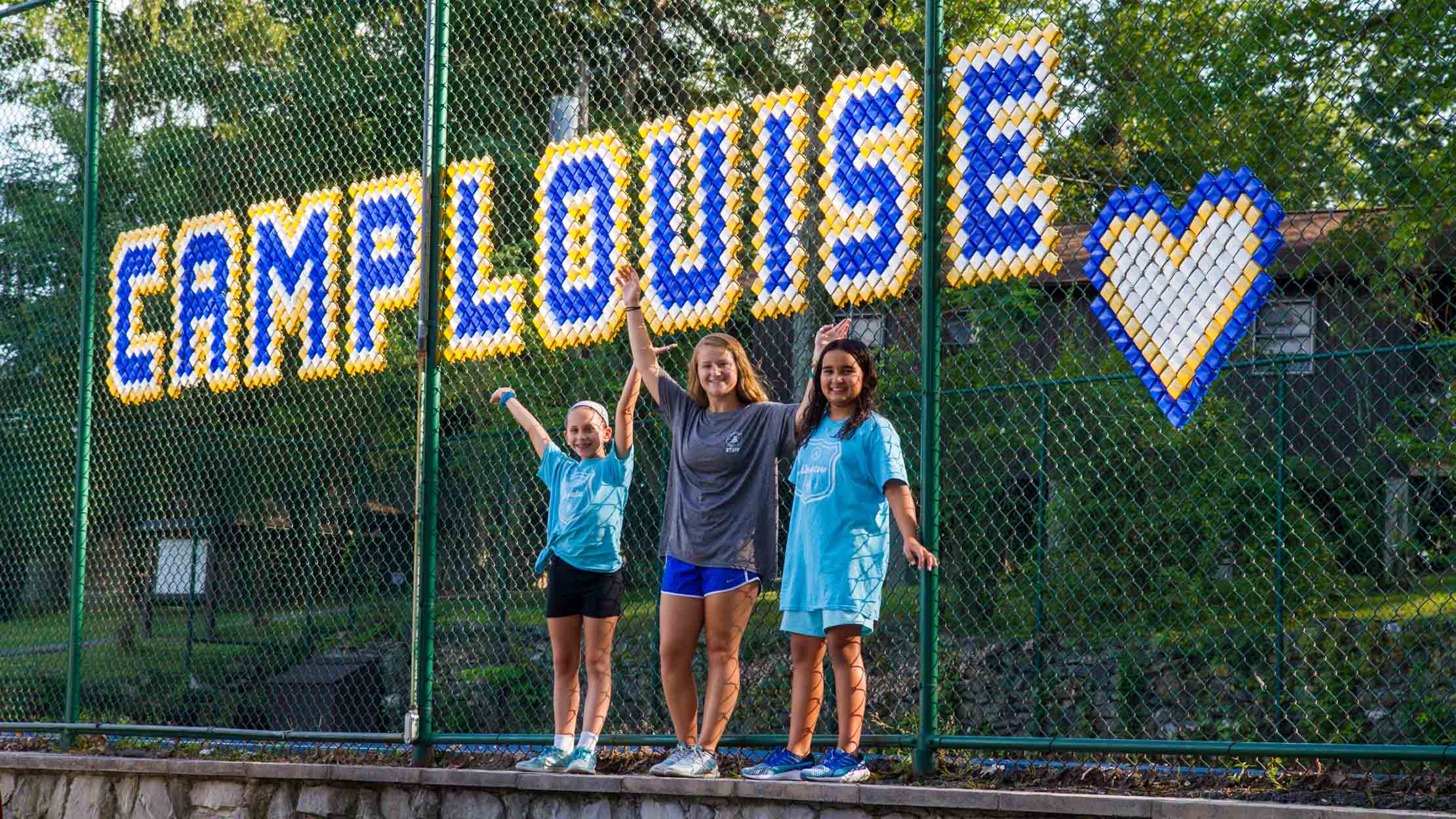 Camp Louise spelled out by tennis court