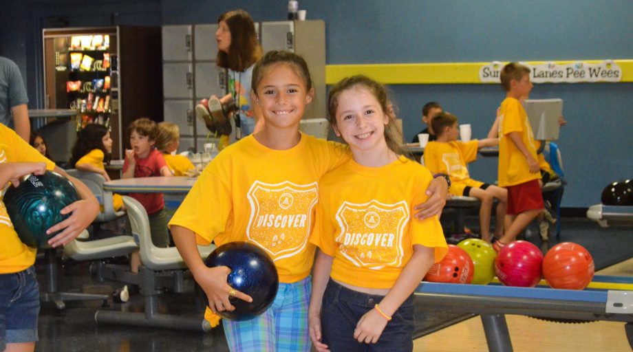 Girls holding a bowling ball