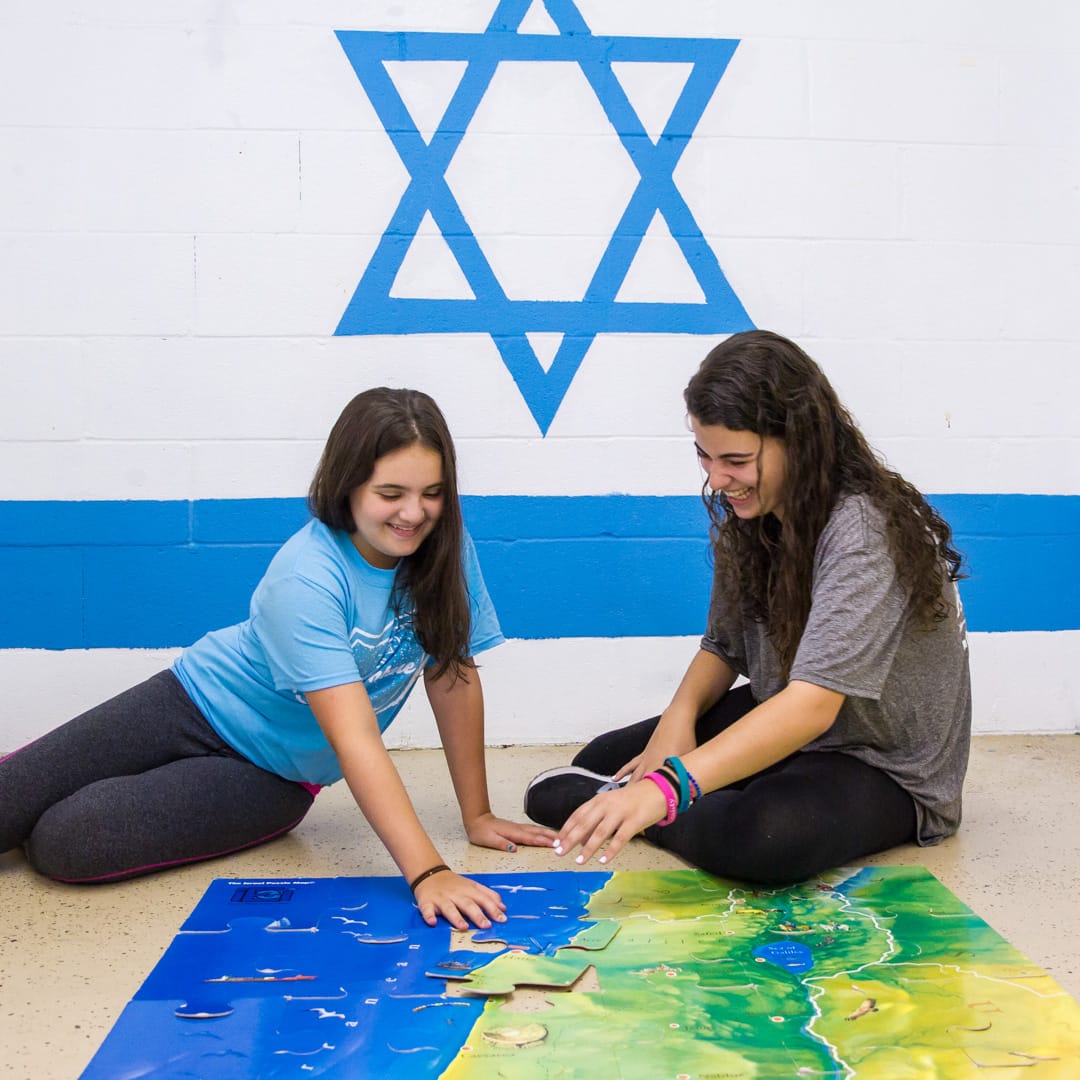 Girls doing a puzzle of Israel