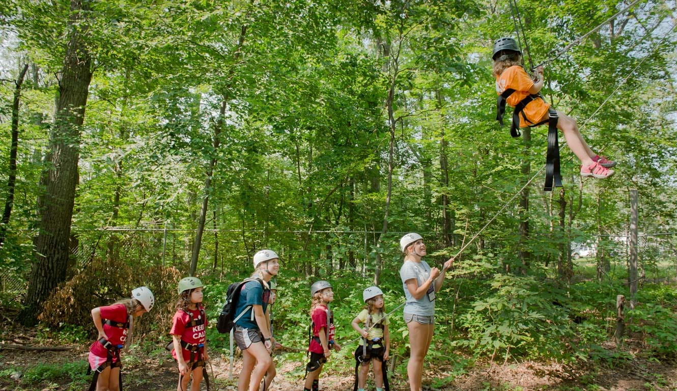 Young Louise camper on high ropes course