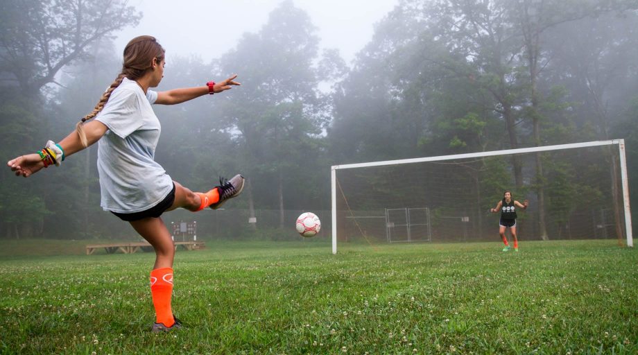 Girl kicking a soccer ball