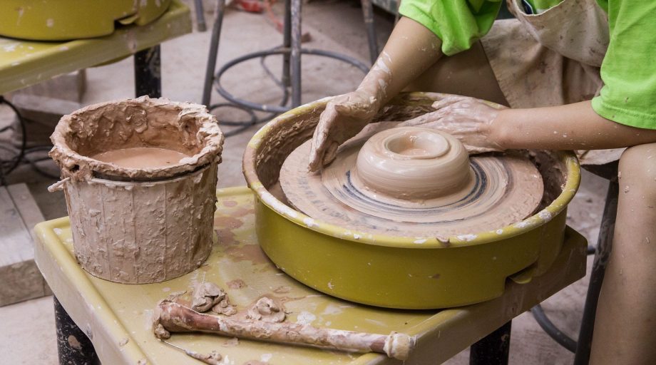 Throwing pottery on the wheel