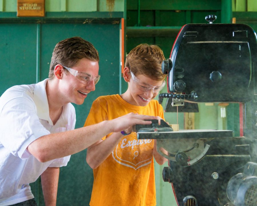 Staff helping a camper at woodworking