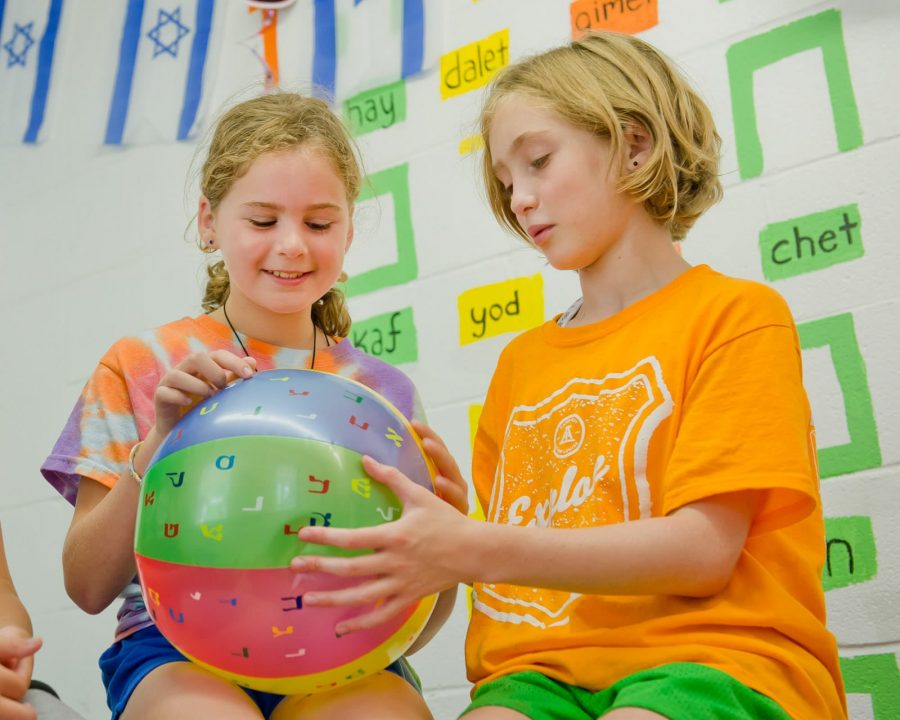 Two Louise campers learning Hebrew