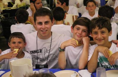 A counselor sitting with kids