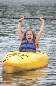 Girl happy in a kayak
